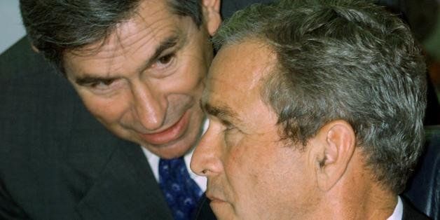 WASHINGTON, UNITED STATES: US President George W. Bush and Deputy Secretary of Defense Paul Wolfowitz (L) speak during a meeting with military leaders at the Pentagon 17 September 2001. President Bush told the media present that the United States wants Saudi-born suspected terror mastermind Osama bin Laden bought to justice 'dead or alive'. AFP PHOTO/Paul J. Richards (Photo credit should read PAUL J. RICHARDS/AFP/Getty Images)