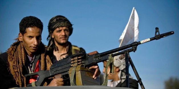 FILE - In this Saturday, Oct. 4, 2014 file photo, A Houthi Shiite rebel holds a weapon while on patrol following dawn prayers attended by supporters of the rebels on the first day of the Muslim holiday of Eid al-Adha, or Feast of the Sacrifice, in Sanaa, Yemen. Yemenâs embattled President Abed Rabbo Mansour Hadi rushed to reach a cease-fire with the countryâs most potent Houthi rebels after hours of gunbattles and firing of mortar shells in heavy clashes near Yemenâs presidential palace Monday, Jan. 19, 2015 morning, according to Yemeni information minister said (AP Photo/Hani Mohammed, File)