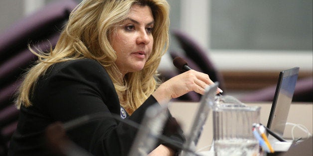 FILE - In this June 3, 2013, file photo, Nevada Assemblywoman Michele Fiore, R-Las Vegas, works in committee during the final day of the 77th Legislative session at the Legislative Building in Carson City, Nev. Taxation Committee Chairwoman Michele Fiore broke her weeklong silence about dozens of tax liens filed against her and her companies, saying an unnamed employee who stole from her and systematically deceived her accountant was at the root of the problem. Fiore, a sophomore Republican lawmaker and Assembly majority leader, told conservative radio host Alan Stock on Tuesday, Dec. 16, 2014, that she has addressed the issue. She also argued that her experience working with the IRS though the resolution process is a reason she should retain her leadership on the tax committee. (AP Photo/Cathleen Allison, File)