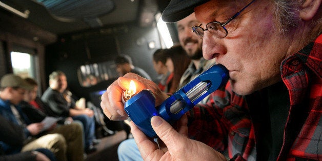 DENVER, CO. - DECEMBER 06: Zane Swiley of Savannah, GA smokes pot on the bus during a marijuana tour hosted by My 420 Tours in Denver, CO on December 06, 2014. Swiley said this was his second tour with the group, its high quality folks, everything they do is first class. During the day tourists visited La Conte's grow facility, La Conte's Clone Bar & Dispensary, Native Roots dispensary and Illuzions Glass Gallery. (Photo By Craig F. Walker / The Denver Post)