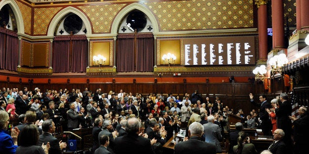 Connecticut Gov. Dannel P. Malloy, right, addresses the House and the Senate at the end of session at the Capitol on the final day of session, Thursday, May 8, 2014, in Hartford, Conn. (AP Photo/Jessica Hill)