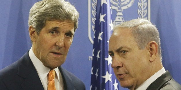 US Secretary of State John Kerry (L) shakes hands with Israeli Prime Minister Benjamin Netanyahu in Tel Aviv on July 23, 2014. Kerry is meeting with United Nations Secretary-General Ban Ki-moon, Netanyahu, and Palestinian president Mahmud Abbas as efforts for a cease-fire between Hamas and Israel continues. AFP PHOTO / POOL (Photo credit should read POOL/AFP/Getty Images)