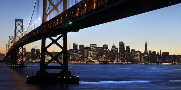 The San Francisco-Oakland Bay Bridge towers over the city skyline at dusk on Wednesday, Jan. 7, 2015, in San Francisco. (AP Photo/Marcio Jose Sanchez)