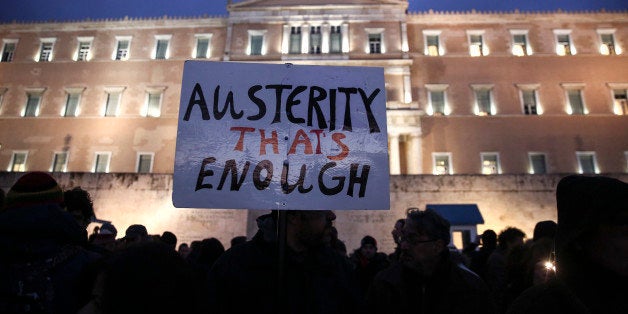 Pro-government protesters gather in front of Greece's parliament to back its demands of a bailout debt renegotiation in central Athens, Wednesday, Feb. 11, 2015. The protests held in Athens and by supporters of the left-wing Syriza party in several other European cities occurred as the new Greek government presented its proposals to skeptical rescue lenders at an emergency Eurogroup meeting in Brussels. (AP Photo/Yorgos Karahalis)