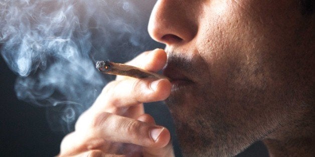 A man smokes a joint during a meeting in celebration of San Canuto's day on the Spanish Canary island of Fuerteventura on January 18, 2015. In Spain, Canute IV or Canute the Holy a former Danish King who became patron saint of Denmark, has seen his feast adopted as a tongue in cheek celebration for the legalization of cannabis, San Canuto's day, stemming from the Spanish colloquialism for a joint, canuto. AFP PHOTO / DESIREE MARTIN (Photo credit should read DESIREE MARTIN/AFP/Getty Images)