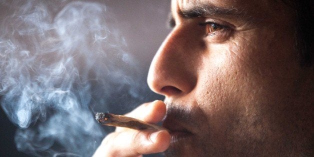 A man smokes a joint during a meeting in celebration of San Canuto's day on the Spanish Canary island of Fuerteventura on Jan
