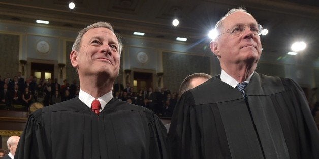 WASHINGTON, DC - JANUARY 20: U.S. Supreme Court Chief Justice John G. Roberts (L) and Justice Anthony M. Kennedy stand before the State of the Union address by President Barack Obama on January 20, 2015 in the House Chamber of the U.S. Capitol in Washington, DC. Obama was expected to lay out a broad agenda to address income inequality, making it easier for Americans to afford college education, and child care. (Photo by Mandel Ngan-Pool/Getty Images)