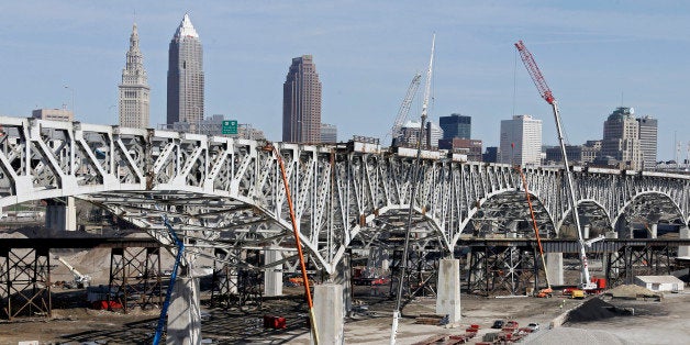 Crews dismantle the old Innerbelt bridge in Cleveland Wednesday, April 16, 2014. Demolition of the old bridge will make way for a new, $273 million span carrying eastbound Interstate 90 over the Cuyahoga River valley. Its completion in 2016 will pair it with a new westbound bridge that opened in November 2013. (AP Photo/Mark Duncan)