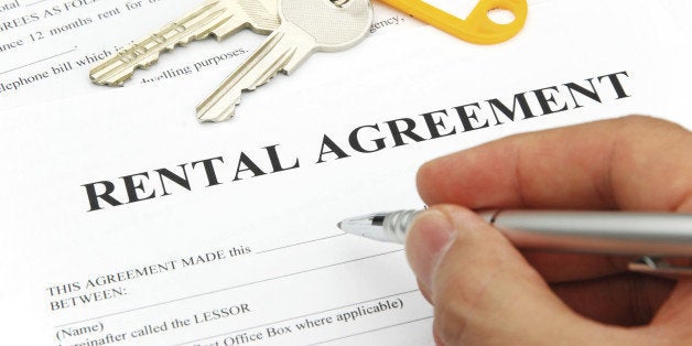 rental agreement form with signing hand and pen and keys