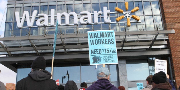 WASHINGTON, DC - NOVEMBER 28: Protesters gather in front of a Walmart store in the nations capital Friday to demand better wages in Washington, DC on November 28,2014. (Photo by Muhammed Bilal Kenasari/Anadolu Agency/Getty Images)