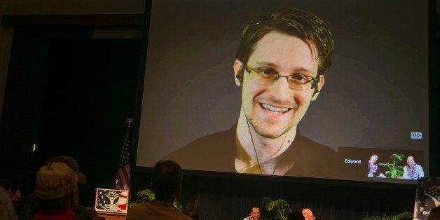 National Security Agency leaker Edward Snowden appears on a live video feed broadcast from Moscow at an event sponsored by the ACLU Hawaii in Honolulu on Saturday, Feb. 14, 2015. (AP Photo/Marco Garcia)