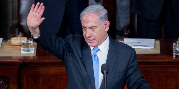 Benjamin Netanyahu, Israel's prime minister, waves after speaking during a joint meeting of Congress in the House Chamber at