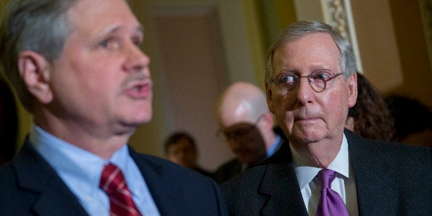 Senate Majority Leader Mitch McConnell, a Republican from Kentucky, right, looks on as John Hoeven, a Republican from North Dakota, speaks during a news conference after a cloture vote on the Keystone XL pipeline bill at the U.S. Capitol in Washington, D.C., U.S., on Thursday, Jan. 29, 2015. U.S. Senate Republicans are poised to push through a bill to approve the Keystone XL pipeline, achieving a long sought policy objective that probably will be thwarted by a veto from President Barack Obama. Photographer: Andrew Harrer/Bloomberg via Getty Images