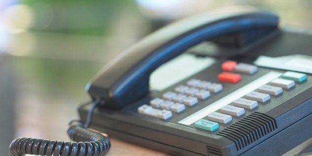 Business telephone with extensions on desk in office