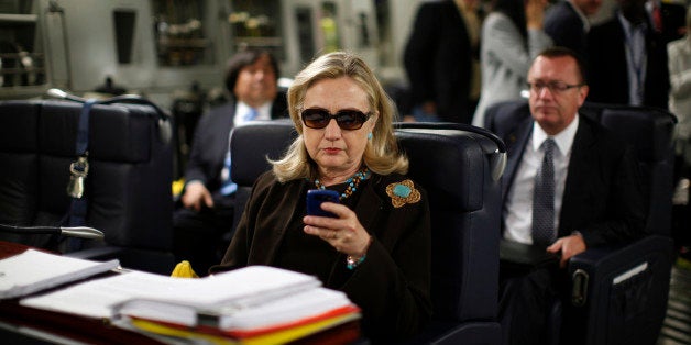 FILE - In this Oct. 18, 2011, file photo, then-Secretary of State Hillary Rodham Clinton checks her Blackberry from a desk inside a C-17 military plane upon her departure from Malta, in the Mediterranean Sea, bound for Tripoli, Libya. Clinton used a personal email account during her time as secretary of state, rather than a government-issued email address, potentially hampering efforts to archive official government documents required by law. Clinton's office said nothing was illegal or improper about her use of the non-government account and that she believed her business emails to State Department and other .gov accounts would be archived in accordance with government rules. (AP Photo/Kevin Lamarque, Pool, File)