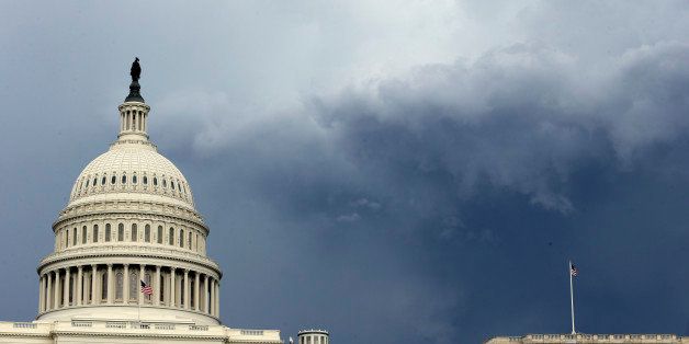 Dark clouds are seen behind the U.S. Capitol as a storm moves through the area, Thursday, June 13, 2013 in Washington. (AP Photo/Alex Brandon)
