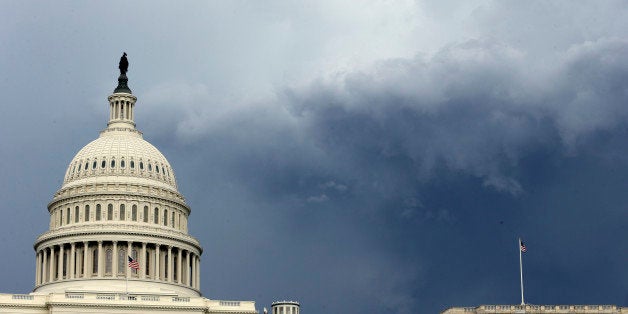 Dark clouds are seen behind the U.S. Capitol as a storm moves through the area, Thursday, June 13, 2013 in Washington. (AP Photo/Alex Brandon)