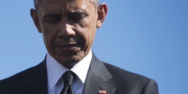 US President Barack Obama closes his eyes during an event marking the 50th Anniversary of the Selma to Montgomery civil rights marches at the Edmund Pettus Bridge in Selma, Alabama, on March 7, 2015. US President Barack Obama rallied a new generation of Americans to the spirit of the civil rights struggle, warning their march for freedom 'is not yet finished.' In a forceful speech in Selma, Alabama on the 50th anniversary of the brutal repression of a peaceful protest, America's first black president denounced new attempts to restrict voting rights. AFP PHOTO/ SAUL LOEB (Photo credit should read SAUL LOEB/AFP/Getty Images)