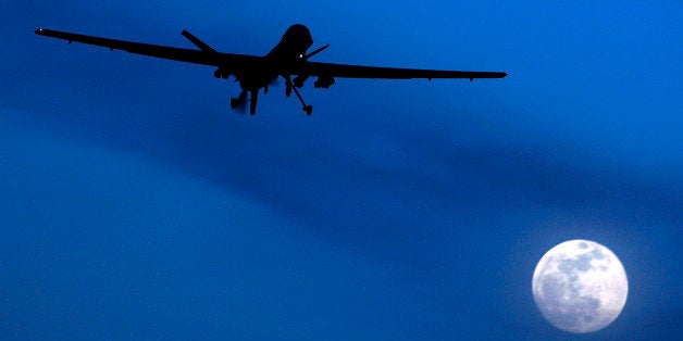 FILE - In this Jan. 31, 2010 file photo, an unmanned U.S. Predator drone flies over Kandahar Air Field, southern Afghanistan, on a moon-lit night. A U.N. expert on Friday, Oct. 18, 2013 called on the United States to reveal the number of civilians it believes have been killed by American drone strikes targeting Islamic militants. U.N. Special Rapporteur Ben Emmerson said that preliminary information gathered for a new report indicated more than 450 civilians may have been killed by drone strikes in Pakistan, Afghanistan and Yemen, but more work needs to be done to confirm the figures.(AP Photo/Kirsty Wigglesworth, File)