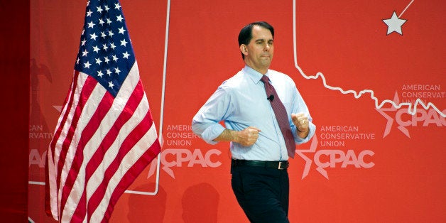 Wisconsin Gov. Scott Walker runs onstage to address the Conservative Political Action Conference (CPAC) in National Harbor, Md., Thursday, Feb. 26, 2015. (AP Photo/Cliff Owen)