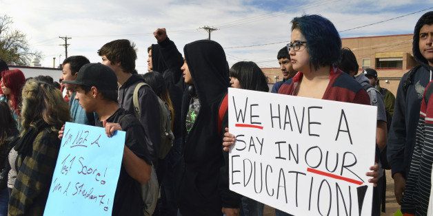 Dolores Ramos, 16, right, joins dozens of Highland High School students in Albuquerque, N.M., as students staged a walkout Monday March 2, 2015, to protest a new standardized test they say isn't an accurate measurement of their education. Students frustrated over the new exam walked out of schools across the state Monday in protest as the new exam was being given. The backlash came as millions of U.S. students start taking more rigorous exams aligned with Common Core standards. (AP Photo/Russell Contreras)