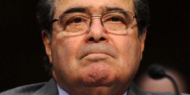 US Supreme Court Justice Antonin Scalia listens, as he along with Justice Stephen Breyer testify before the Senate Judiciary Committee at a hearing entitled, âConsidering the Role of Judges Under the Constitution of the United States' at the Hart Senate Office Building in Washington, DC, on October 5, 2011. AFP Photo/Jewel Samad (Photo credit should read JEWEL SAMAD/AFP/Getty Images)