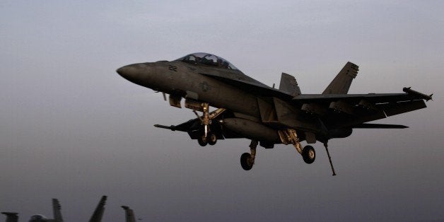 FILE - In this Aug. 10, 2014 file photo, an aircraft lands after missions targeting the Islamic State group in Iraq from the deck of the U.S. Navy aircraft carrier USS George H.W. Bush in the Persian Gulf. Combined U.S.-Arab airstrikes at the heart of the Islamic State group's military strongholds in Syria achieved their strategic aim of showing the extremists that their savage attacks will not go unanswered, the top American military officer said Tuesday, Sept. 23, 2014. (AP Photo/Hasan Jamali, File)