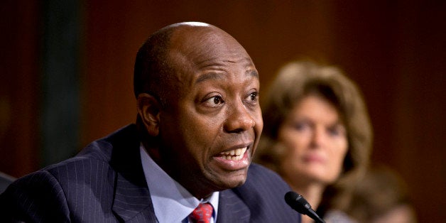 Senate Health, Education, Labor, and Pensions Committee member Sen. Tim Scott, R-S.C., questions Medicare chief Marilyn Tavenner on Capitol Hill in Washington, Tuesday, Nov. 5, 2013, as she testified before the committee's hearing as the panel seeks reassurances about problems with the debut of the Affordable Care Act. At right is Sen. Lisa Murkowski, R-Alaska. Republicans on the committee emphasized their longstanding criticism of the law, citing examples of cancellations and increased costs while raising questions about cyber-security for healthcare.gov. (AP Photo/J. Scott Applewhite)