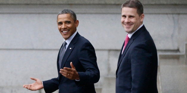 President Barack Obama, accompanied by White House Communications Director Dan Pfeiffer, reacts to a reporter's question abou
