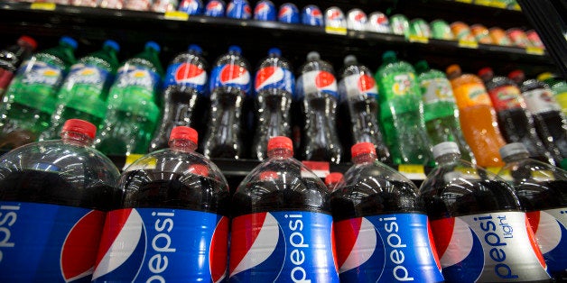 Bottles of PepsiCo Inc. Pepsi soft drinks sit on display at a store in Mexico City, Mexico, on Monday, July 22, 2013. PepsiCo Inc. is expected to release earnings data on July 24. Photographer: Susana Gonzalez/Bloomberg via Getty Images