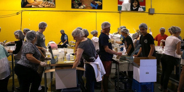 SAN FRANCISCO, CA - MAY 01: Volunteers pack bags of oatmeal at the SF-Marin Food Bank on May 1, 2014 in San Francisco, California. Food banks are bracing for higher food costs and an increased demand for food from the needy as food prices are skyrocketing due to a reduction in food stamps and drought conditions in several states. (Photo by Justin Sullivan/Getty Images)