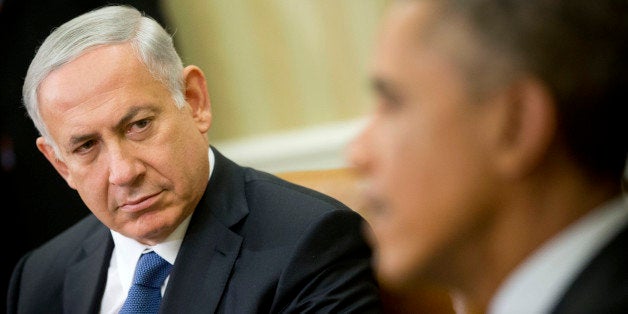 Israeli Prime Minister Benjamin Netanyahu listens as President Barack Obama speaks during their meeting in the Oval Office of