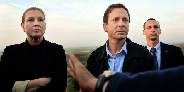 FILE - In this Thursday, Dec. 11, 2014 file photo, Israeli politicians Isaac Herzog, right, and Tzipi Livni listen during a t
