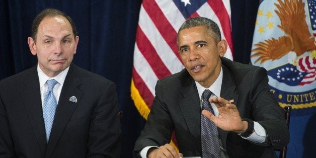 US President Barack Obama speaks alongside Secretary of Veterans Affairs Robert McDonald (L) following a briefing on US military veterans healthcare at the Veterans Affairs (VA) Medical Center in Phoenix, Arizona, March 13, 2015. The government announced a new advisory committee of private sector, non-profit and government leaders to improve the VA's ability to improve care for veterans from the Phoenix VA that was at the center of scandal last year regarding the health care of US military veterans. AFP PHOTO / SAUL LOEB (Photo credit should read SAUL LOEB/AFP/Getty Images)