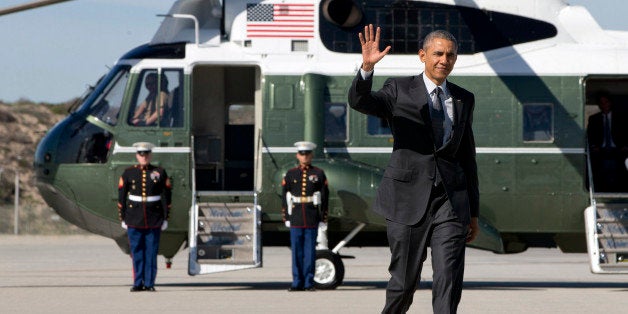 President Barack Obama waves as walks to board Air Force One on departure from Los Angeles International Airport, Friday, Mar