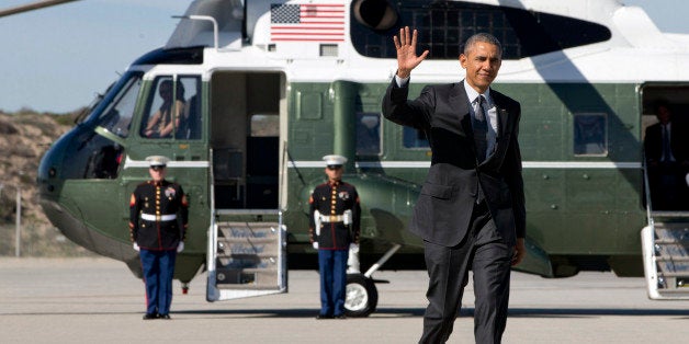 President Barack Obama waves as walks to board Air Force One on departure from Los Angeles International Airport, Friday, March 13, 2015, en route to Phoenix. (AP Photo/Jacquelyn Martin)