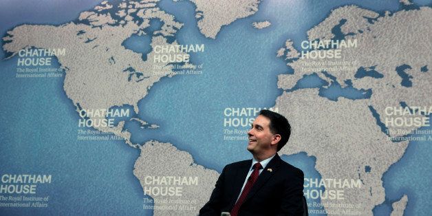 Wisconsin Gov. Scott Walker laughs as he is introduced prior to his speech at Chatham House in central London, Wednesday, Feb. 11, 2015. Walker is leading a coalition of Wisconsin government and business officials on a trade mission in the UK that runs until Friday, Feb. 13, 2015. The trip gives him a chance to bolster his overseas and foreign policy credentials as he considers running for US President in 2016. (AP Photo/Lefteris Pitarakis)