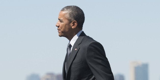 US President Barack Obama walks across the tarmac upon arrival on Air Force One at Phoenix Sky Harbor International Airport i