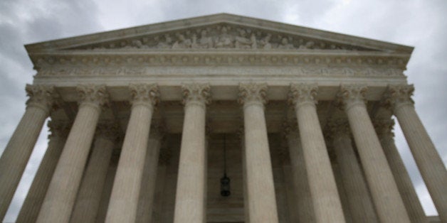 WASHINGTON, DC - AUGUST 20: A guard stands on the steps of the Supreme Court Building, August 20, 2014 in Washington, DC. Today the high court blocked gay and lesbian couples from marrying in Virginia and puts on hold a federal appeals court's verdict last month striking down the state's ban on gay marriage. (Photo by Mark Wilson/Getty Images)