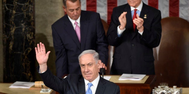 Israeli Prime Minister Benjamin Netanyahu waves as he speaks before a joint meeting of Congress on Capitol Hill in Washington