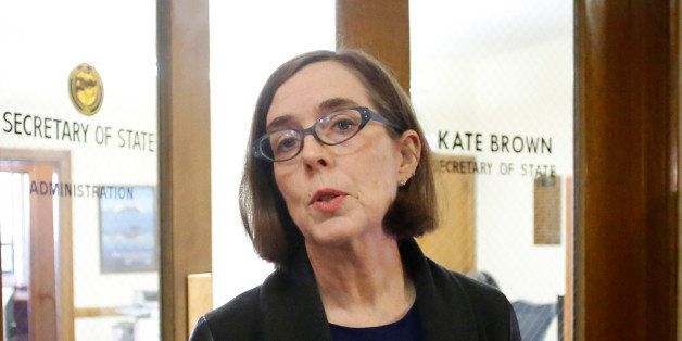 FILE - In this Feb. 13, 2015 file photo, Oregon Secretary of State Kate Brown speaks to the media outside of her office at the Oregon Capitol in Salem, Ore. Brown faces a monumental challenge as she takes the reins of a state government mired in scandal on less than a weekâs notice and with a special election already looming. Americaâs first bisexual governor will be sworn in Wednesday, Feb. 18, 2015, becoming Oregonâs 38th leader after fellow Democrat John Kitzhaber resigned amid ethics questions. (AP Photo/Timothy J. Gonzalez, file)