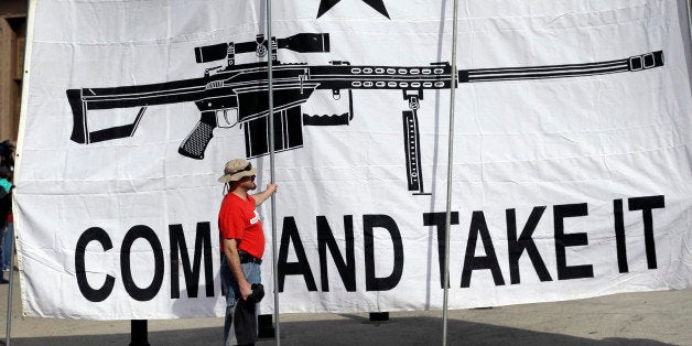 A demonstrator helps hold a large "Come and Take It" banner at a rally in support of open carry gun laws at the Capitol, Monday, Jan. 26, 2015, in Austin, Texas. (AP Photo/Eric Gay)