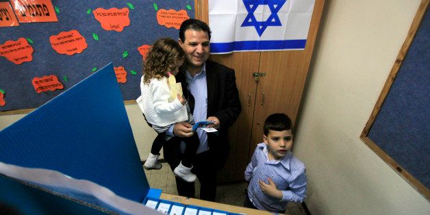 Ayman Odeh, head of the Joint List, an alliance of four small Arab-backed parties, prepares to vote in Haifa, Israel, Tuesday, March 17, 2015. Israelis are voting in early parliament elections following a campaign focused on economic issues such as the high cost of living, rather than fears of a nuclear Iran or the Israeli-Arab conflict. (AP Photo/Mahmoud Illean)