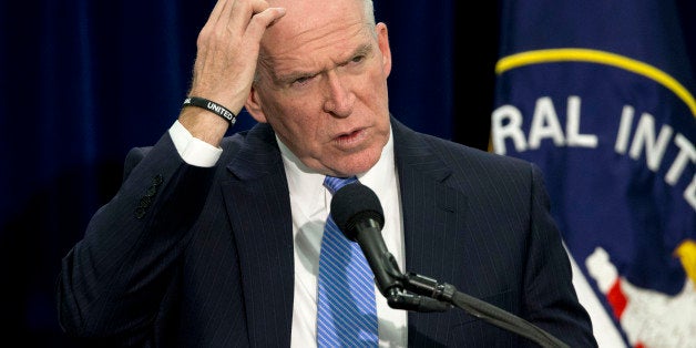 CIA Director John Brennan gestures during a news conference at CIA headquarters in Langley, Va., Thursday, Dec. 11, 2014. Bre