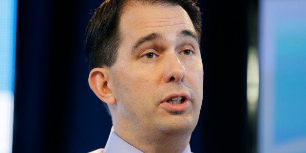 FILE - In this March 7, 2015 file photo, Wisconsin Gov. Scott Walker speaks during the Iowa Agriculture Summit in Des Moines, Iowa. Known for his accessibility and willingness to always be available to take questions, even after the most routine appearances, Walker has suddenly become much harder to reach as he ramps up for a likely 2016 presidential campaign and deals with a series of flubs and shifts in position on hot button issues. (AP Photo/Charlie Neibergall)