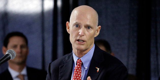 FILE - In this Feb. 5, 2015 file photo, Florida Gov. Rick Scott gestures during a cabinet meeting at the Florida State Fair, in Tampa, Fla. Scott, who has repeatedly tangled with public record advocates, media organizations and others over whether he has followed the stateâs transparency law, has insisted did not use private email accounts for state business. (AP Photo/Chris O'Meara, file)