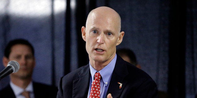 FILE - In this Feb. 5, 2015 file photo, Florida Gov. Rick Scott gestures during a cabinet meeting at the Florida State Fair,