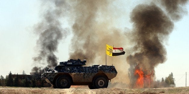 TIKRIT, IRAQ - MARCH 11: Smoke trails over during clashes between Iraqi army forces, supported by Shiite militias, and Daesh (Islamic State of Iraq and the Levant) in Tikrit, Iraq on March 11, 2015. (Photo by Ali Mohammed/Anadolu Agency/Getty Images)