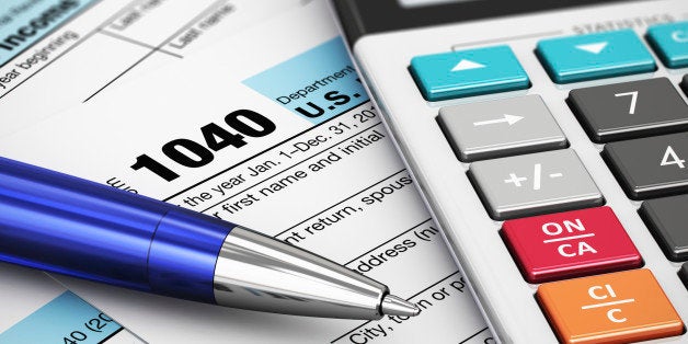 Macro view of 1040 US Tax Form, calculator and ballpoint pen