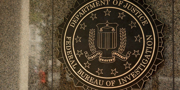 The seal of the Federal Bureau of Investigation (FBI) is seen at the J. Edgar Hoover building in Washington, D.C., U.S., on Thursday, Aug. 8, 2013. The FBI is a governmental agency as a division of the U.S. Department of Justice (DOJ) established in 1908. Photographer: Andrew Harrer/Bloomberg via Getty Images